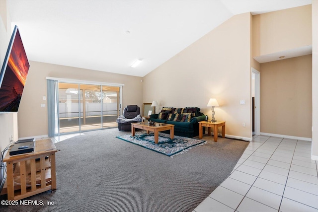 living room featuring light tile patterned flooring and high vaulted ceiling