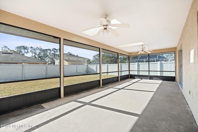 unfurnished sunroom featuring ceiling fan