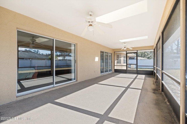 unfurnished sunroom featuring a skylight and ceiling fan