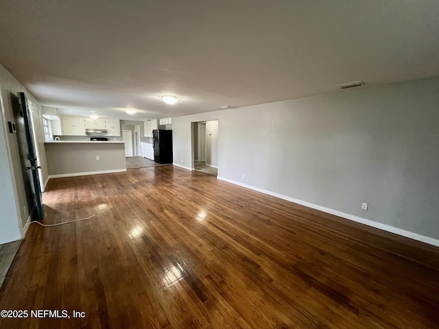 unfurnished living room featuring dark hardwood / wood-style flooring