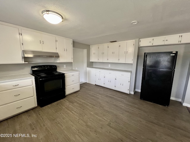 kitchen featuring dark hardwood / wood-style floors, white cabinets, and black appliances