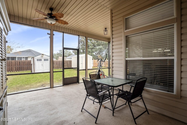 sunroom / solarium featuring ceiling fan and wood ceiling