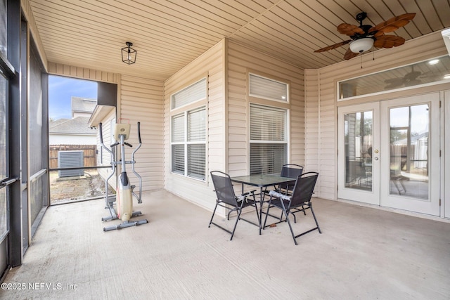 sunroom / solarium with ceiling fan, wood ceiling, and french doors