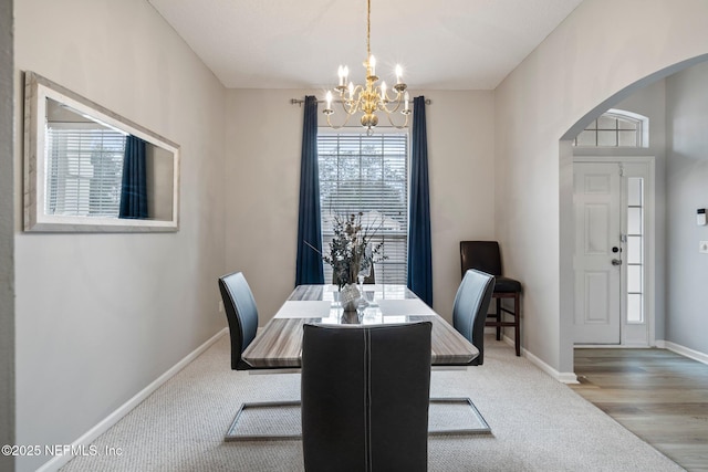 dining room featuring light wood-type flooring and a chandelier