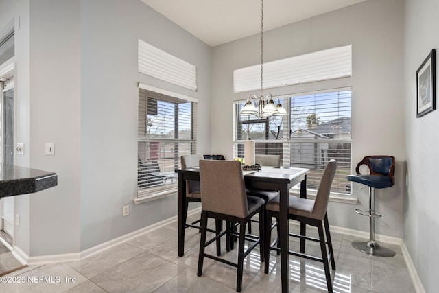 tiled dining area featuring an inviting chandelier and a towering ceiling