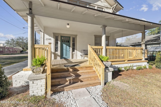 wooden terrace featuring covered porch