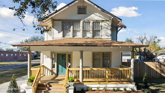 rear view of house with covered porch