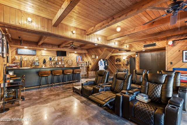 home theater featuring beamed ceiling, wooden walls, bar, and ceiling fan