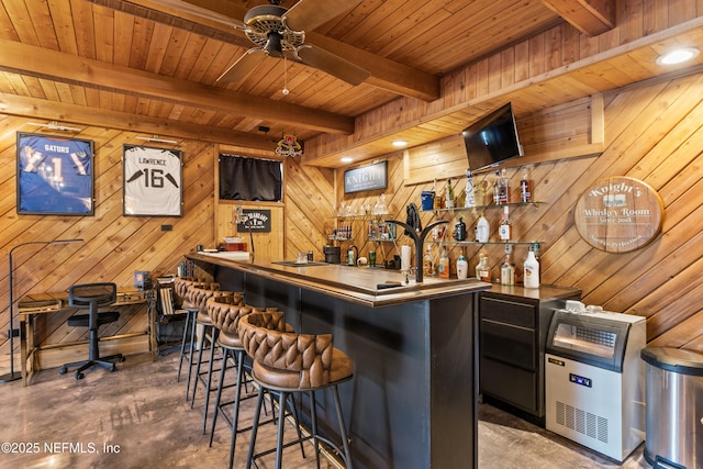 bar with concrete flooring, wood walls, ceiling fan, wood ceiling, and beam ceiling