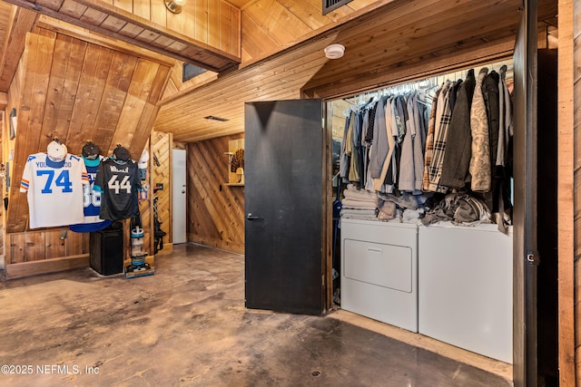 interior space featuring separate washer and dryer and wood walls