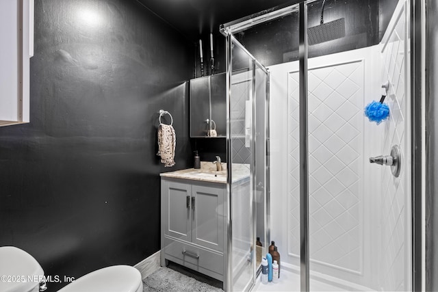 bathroom with vanity, toilet, and an enclosed shower