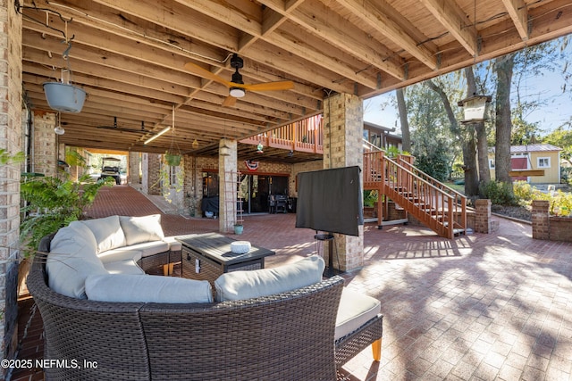 view of patio / terrace featuring ceiling fan and an outdoor living space