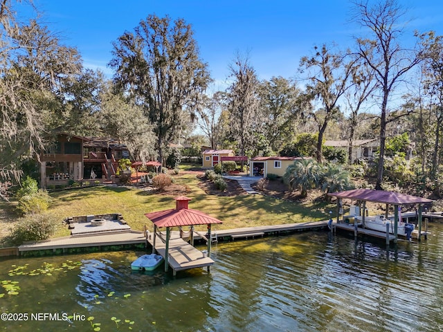 dock area with a water view and a yard