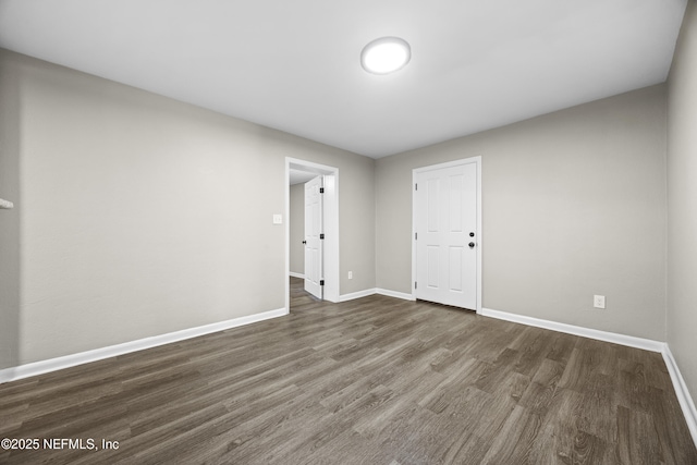 unfurnished room featuring dark wood-type flooring