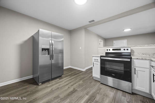 kitchen featuring white cabinetry, appliances with stainless steel finishes, and wood-type flooring