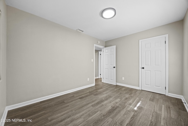 unfurnished bedroom with wood-type flooring