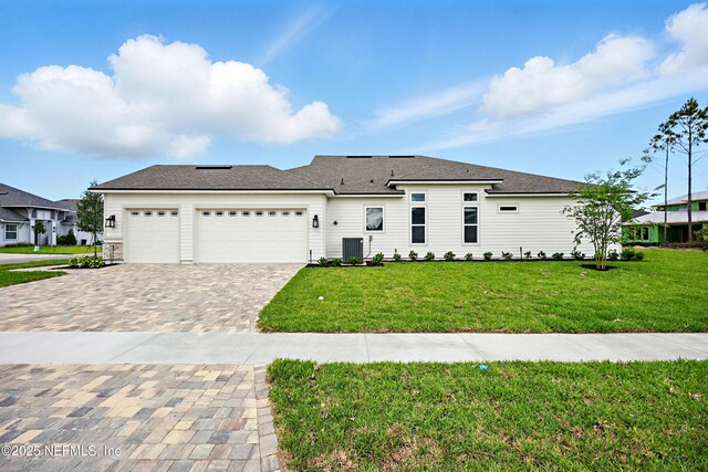56 Pine Grove Pt, Saint Augustine, FL 32092 - view of front of house with decorative driveway, a garage, a front yard, and central AC