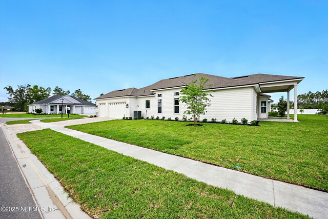 56 Pine Grove Pt, Saint Augustine, FL 32092 - view of front of house featuring a front yard, a garage, driveway, and central AC unit