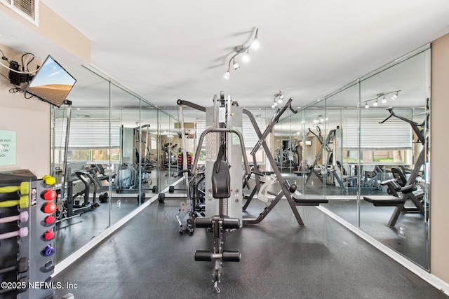 gym featuring track lighting