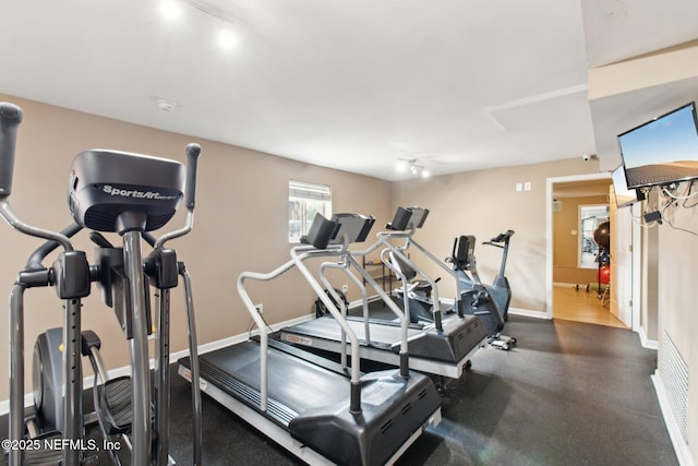 workout area featuring track lighting