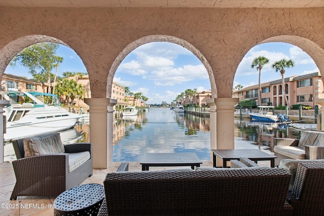 view of patio / terrace featuring a water view and a boat dock