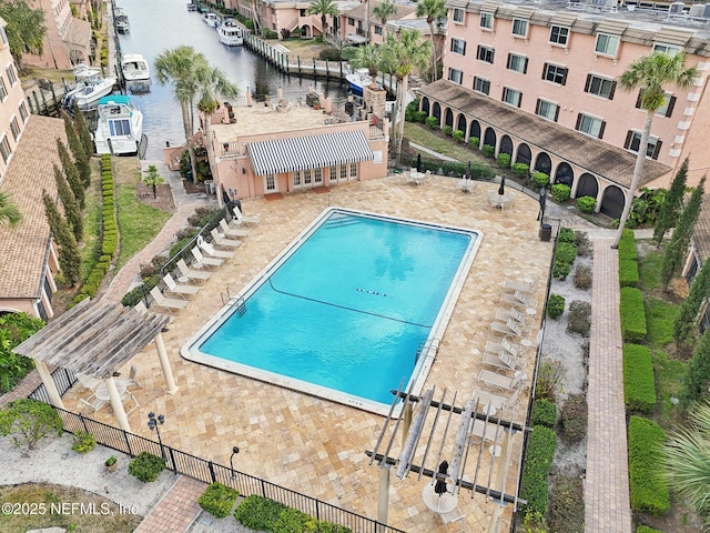 view of swimming pool featuring a pergola, a patio area, and a water view