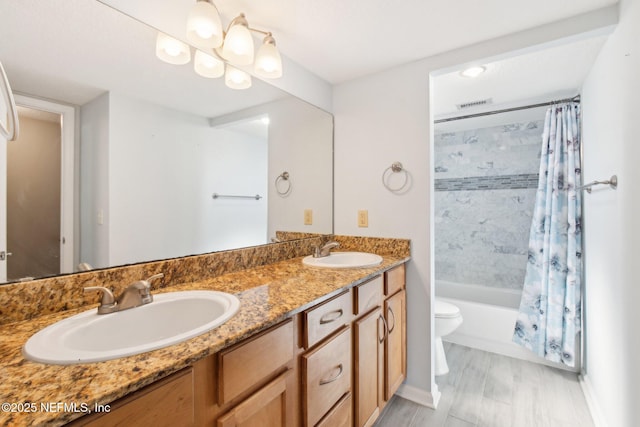 full bathroom with vanity, shower / bath combination with curtain, and toilet