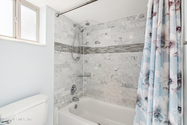 bathroom featuring shower / bath combination with curtain and toilet