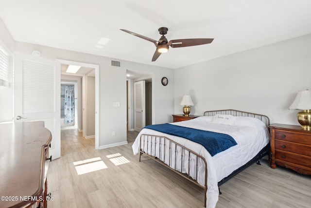 bedroom with a closet, ceiling fan, and light hardwood / wood-style flooring