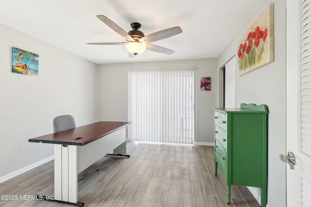 office space with light hardwood / wood-style floors and ceiling fan