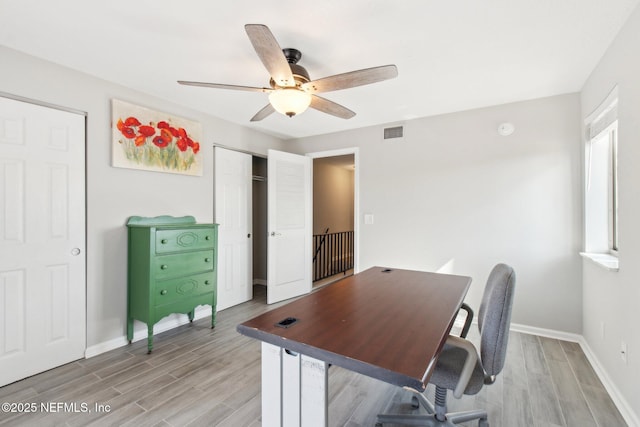 office space with ceiling fan and light hardwood / wood-style floors