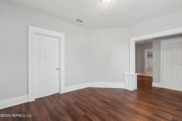 unfurnished room with dark hardwood / wood-style floors