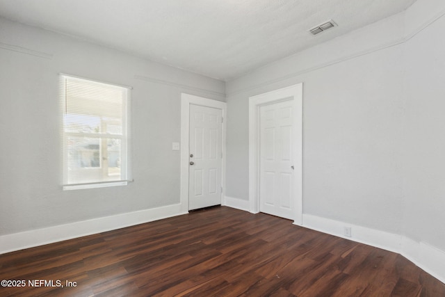 unfurnished room with dark hardwood / wood-style floors