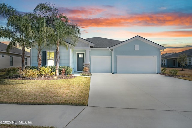 view of front of house with a garage and a lawn