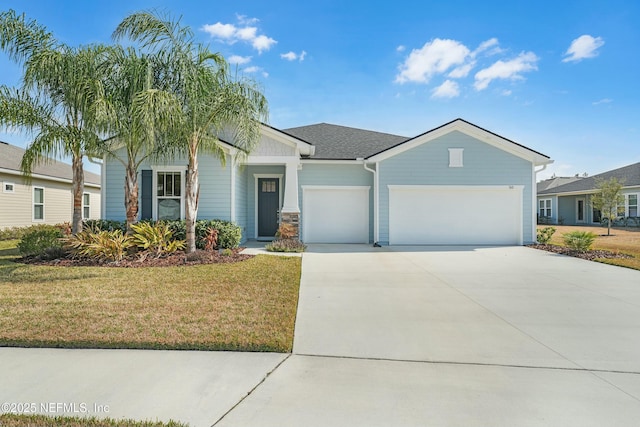 view of front of house featuring a garage and a front lawn