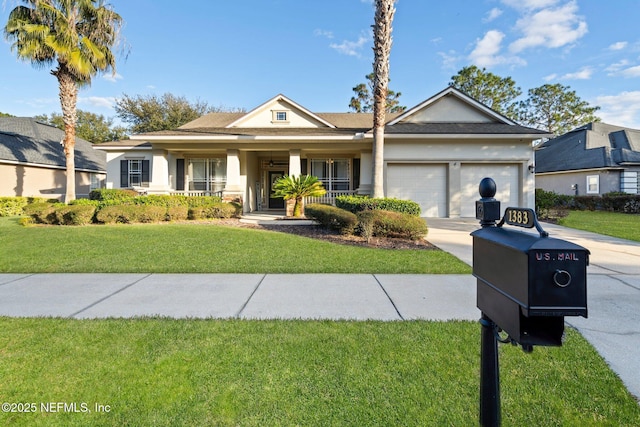 view of front of property with a porch, a garage, and a front yard