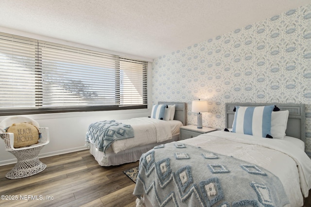 bedroom with hardwood / wood-style floors and a textured ceiling