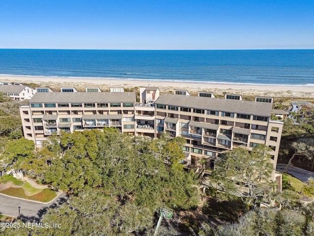 drone / aerial view featuring a water view and a beach view