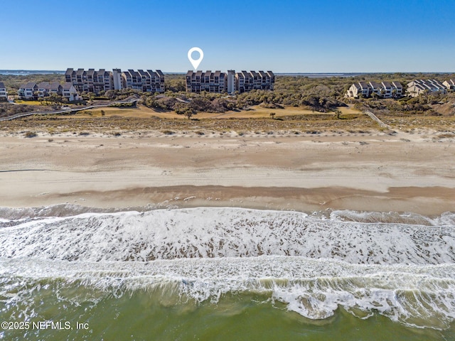 bird's eye view with a water view and a beach view