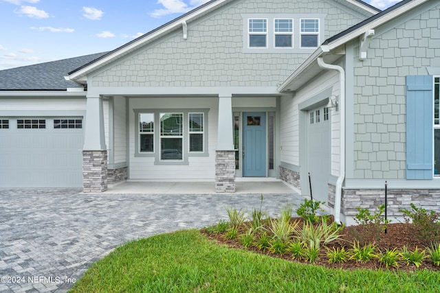 view of front of home featuring a porch and a garage