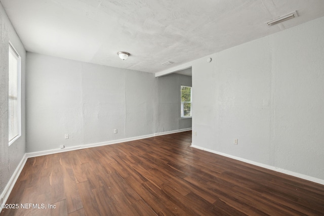 spare room featuring dark hardwood / wood-style flooring