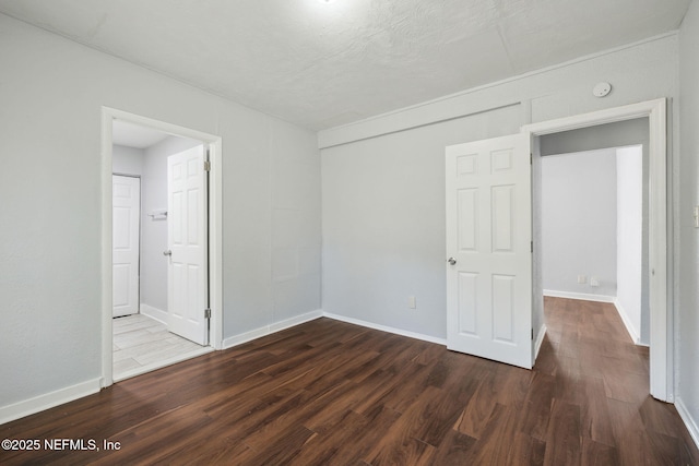 unfurnished bedroom featuring dark hardwood / wood-style floors