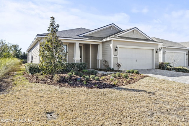 view of front of house with a garage and a front lawn