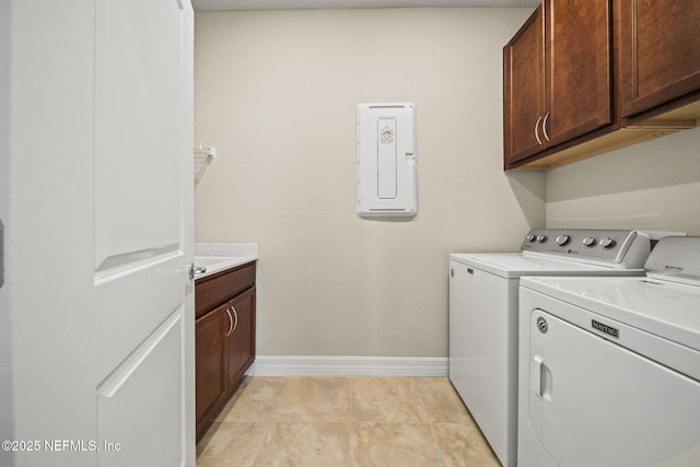 washroom featuring separate washer and dryer, cabinets, and light tile patterned flooring