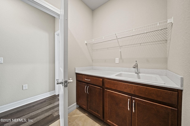 washroom with sink and light hardwood / wood-style flooring