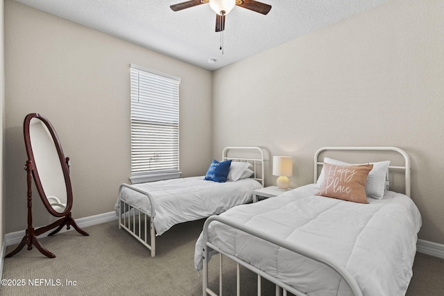 bedroom featuring a textured ceiling, ceiling fan, and carpet