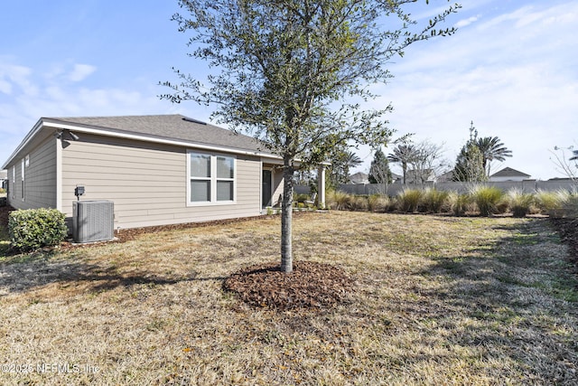 view of home's exterior featuring central AC unit and a lawn