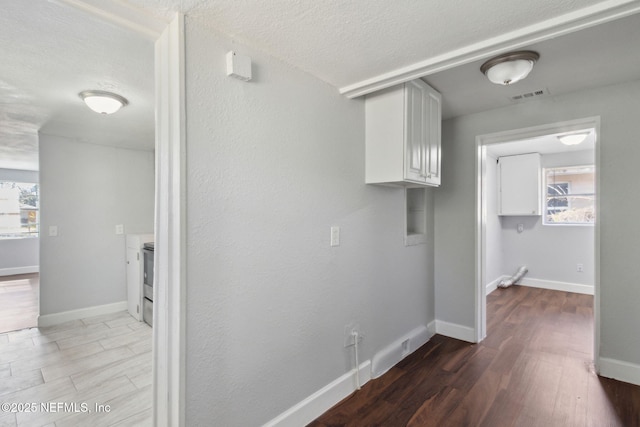 interior space with hardwood / wood-style flooring and a textured ceiling