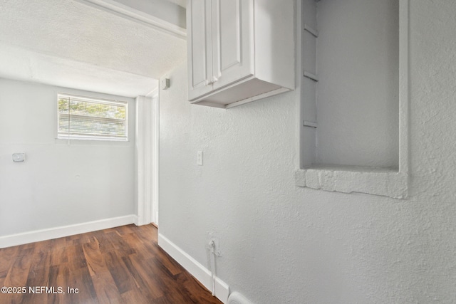 interior space featuring dark hardwood / wood-style floors and a textured ceiling