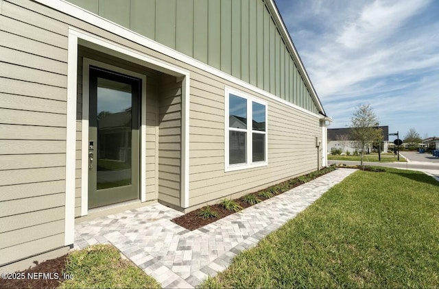 view of side of property with a lawn